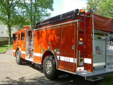 Rear-right exterior view showing side compartments and rear wheel area