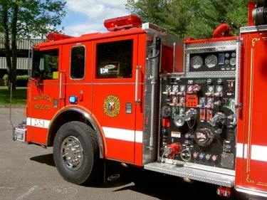 Pump panel close-up showing gauges, valves, and intake connections