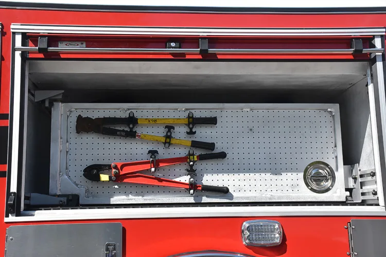 Open side compartment showing mounted long tools in horizontal rack