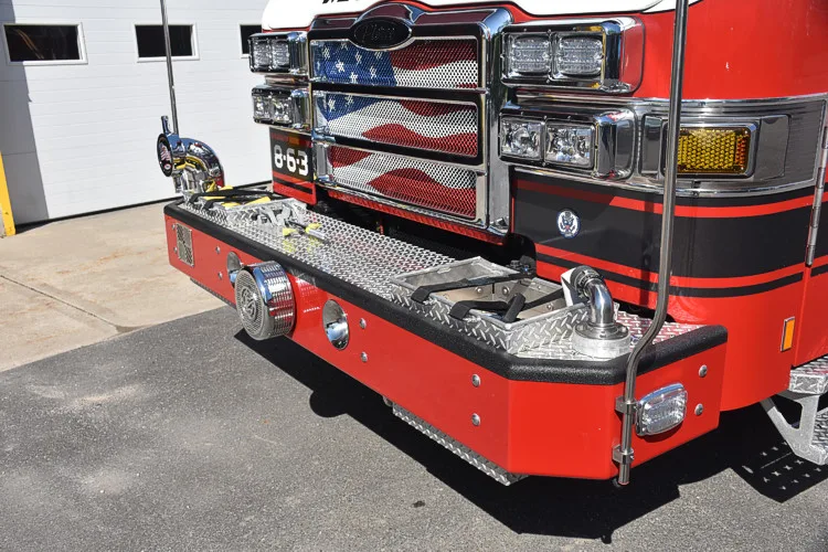 Front bumper close-up showing intake fittings, grille, and chrome trim