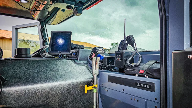 Cab interior view showing center console, seats, and workstation area