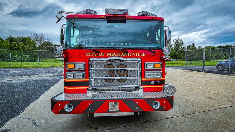 Head-on front view showing grille, bumper intakes, and warning lights
