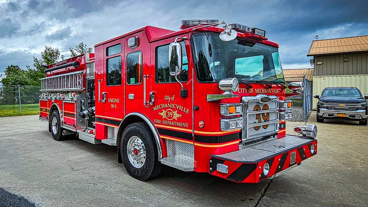 Front-left exterior profile showing pumper body and side compartments