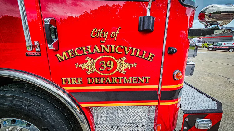 Cab door close-up showing city fire department lettering and crest
