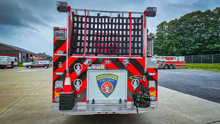 Rear view showing red-and-yellow chevrons and center rear crest panel