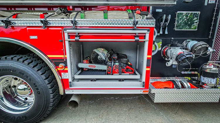 Open side compartment showing pump plumbing and hose connections