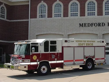 Left-side profile view highlighting long rescue compartments and cab-to-body configuration.