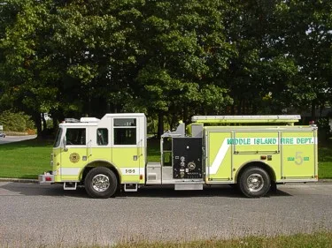 Driver-side full profile showing pump controls, side compartments, and body length.