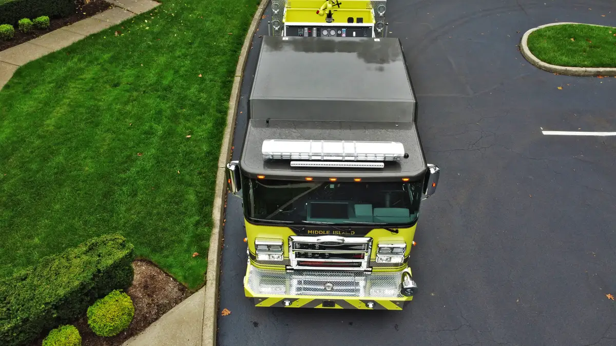 Aerial top-down front-left view showing roof layout, hosebed, and body lines