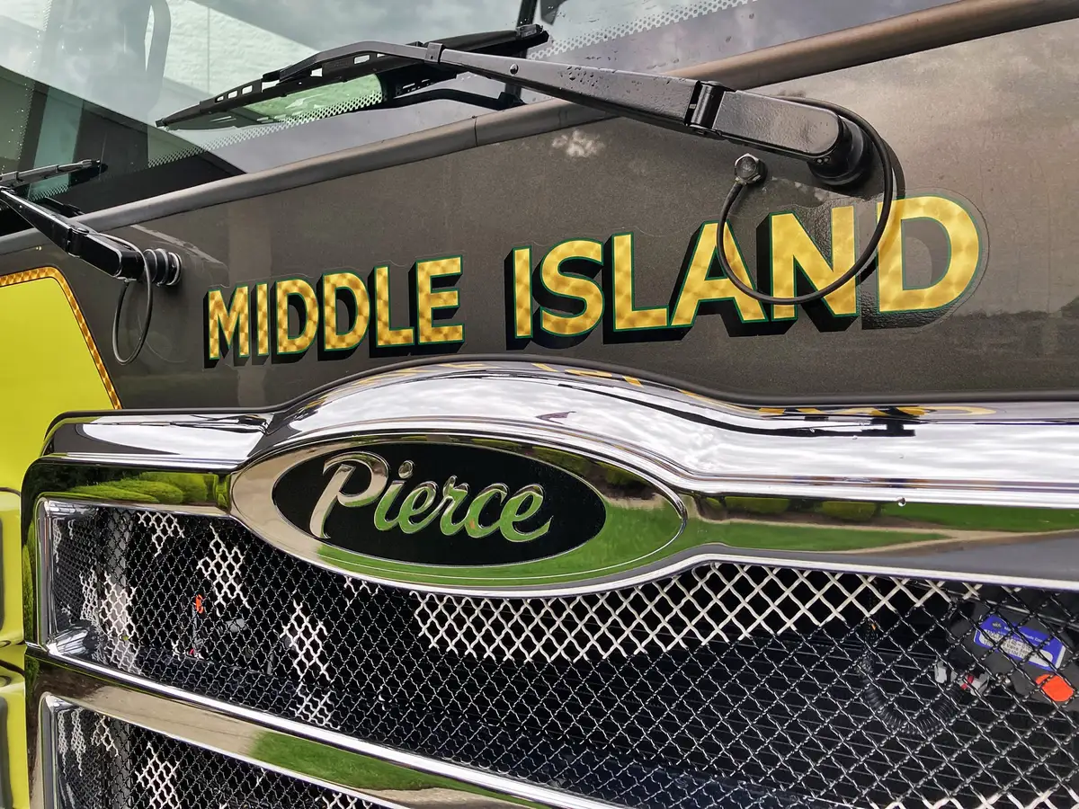 Front-left exterior view showing grille, bumper, and warning lights