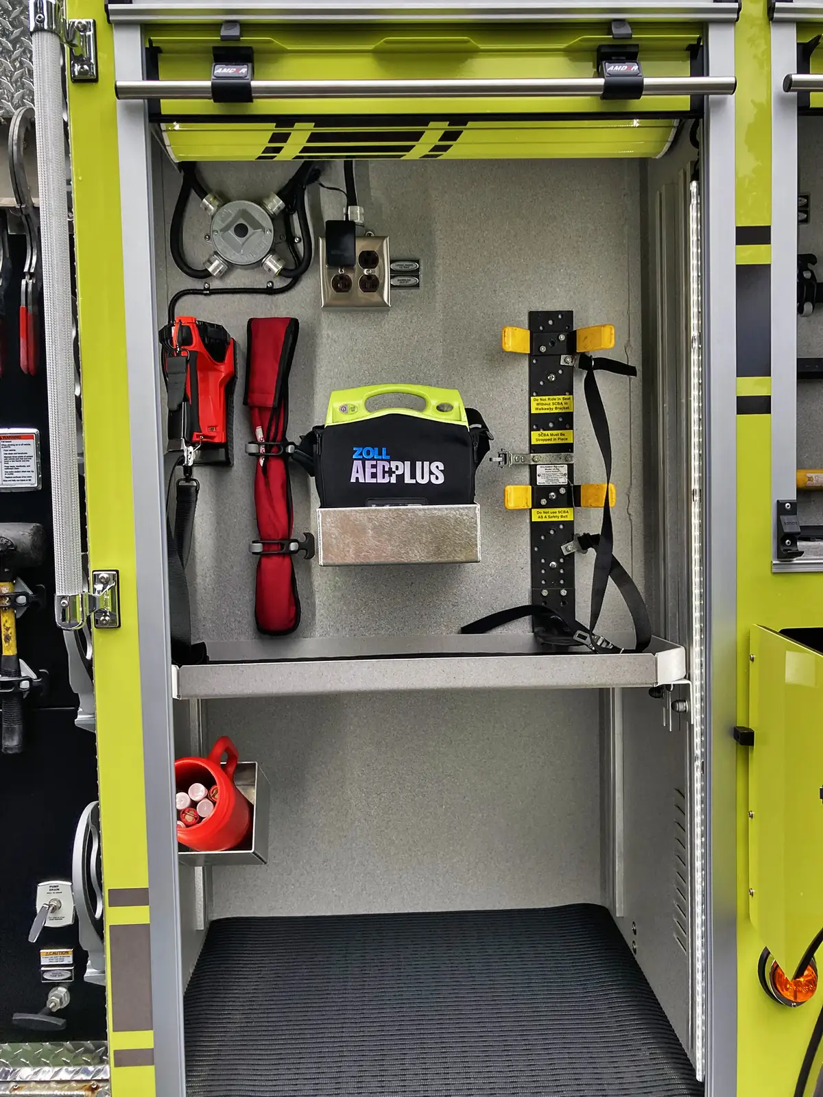 Rear exterior view showing chevrons, warning lights, and hosebed opening