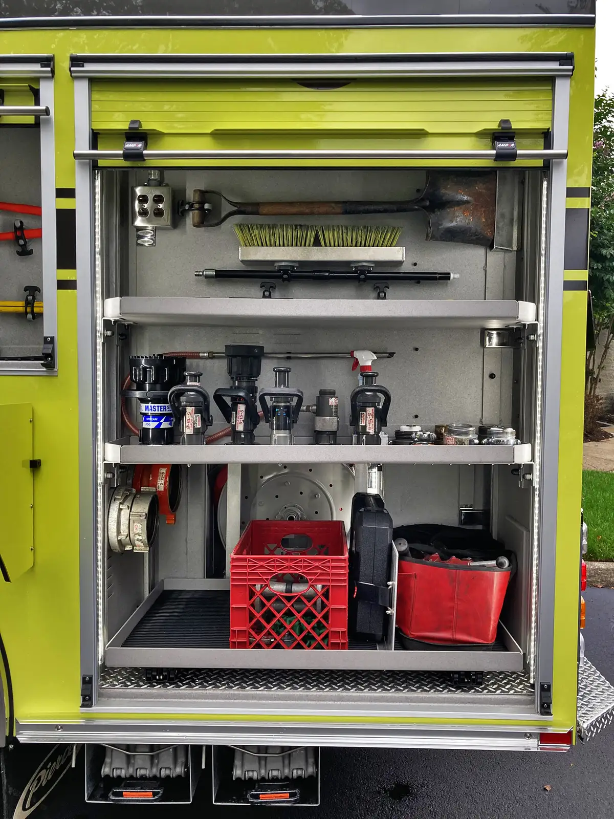 Open side compartment showing shelves, trays, and equipment storage