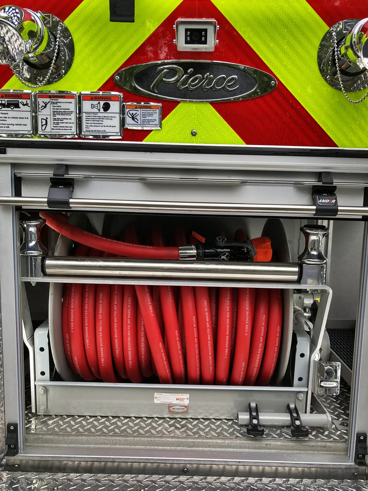 Open compartment close-up showing pull-out tray and mounted tool brackets