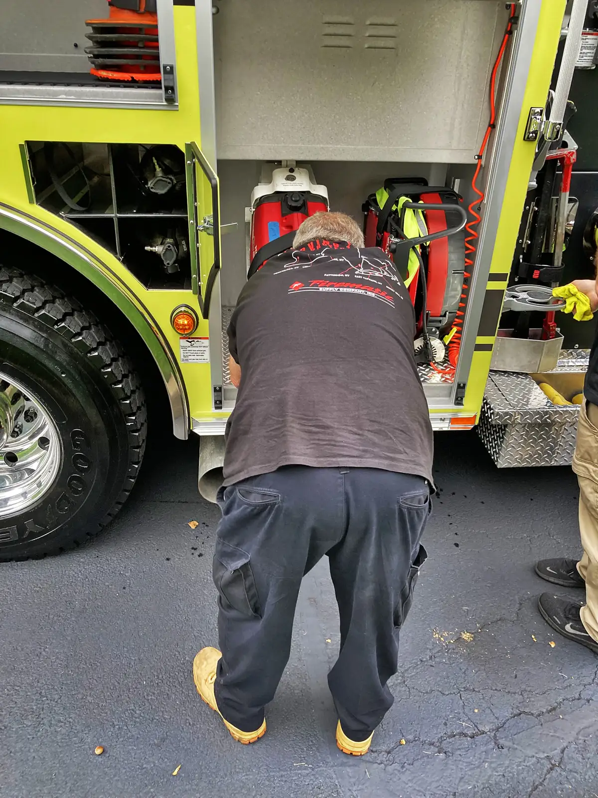 Narrow vertical compartment open showing long-tool storage channel