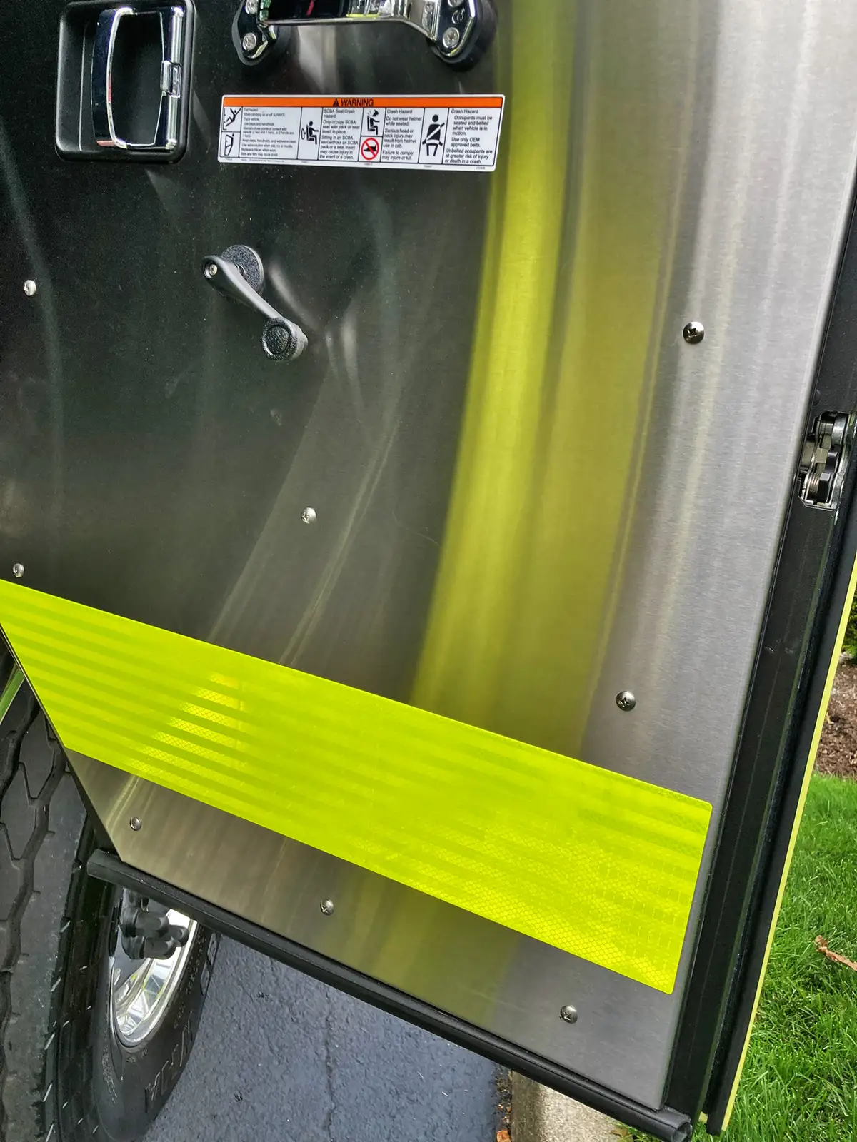 Driver cockpit close-up showing steering wheel, instrument cluster, and switches