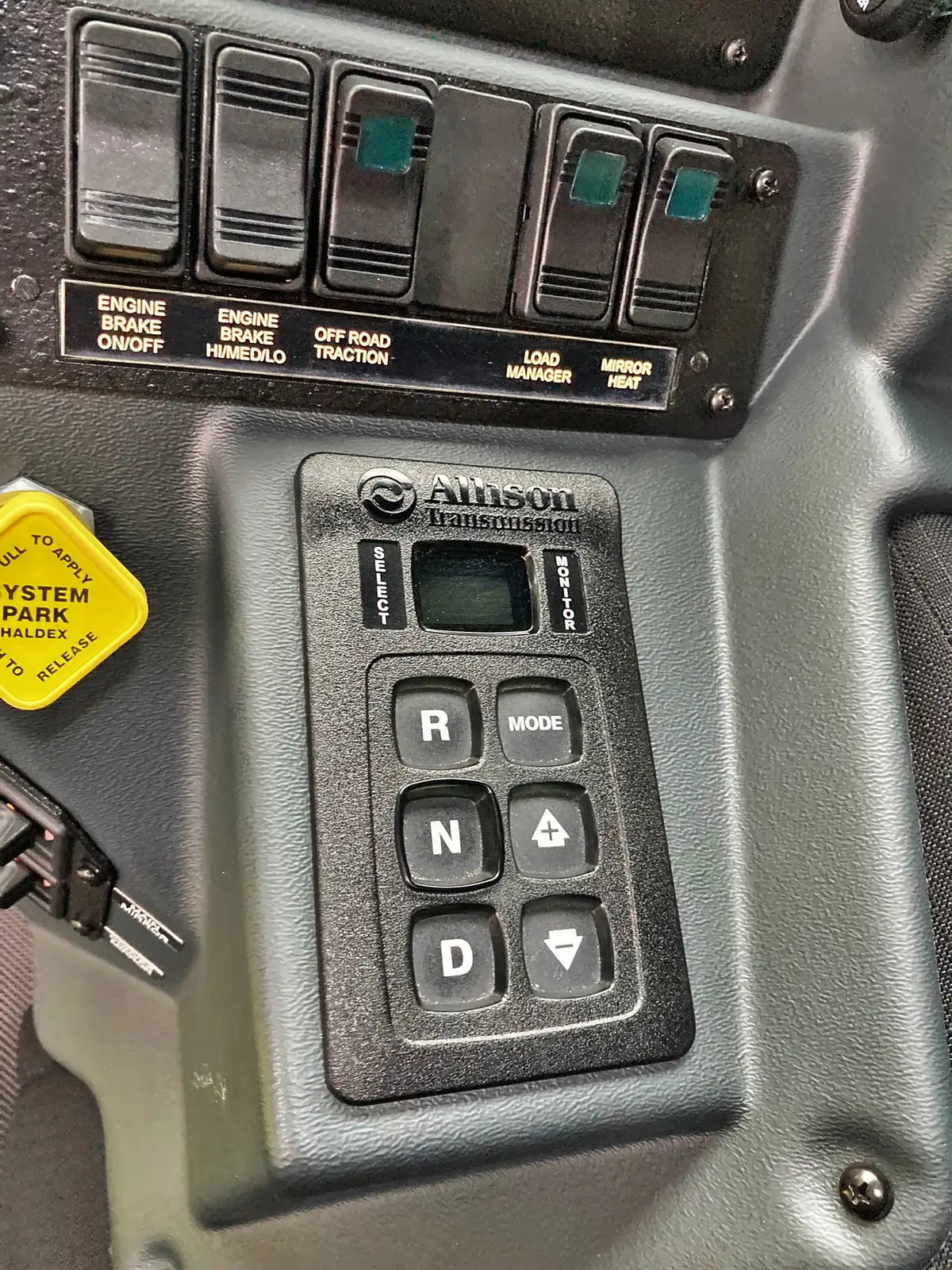 Open compartment showing rescue tools, saw storage, and mounting brackets