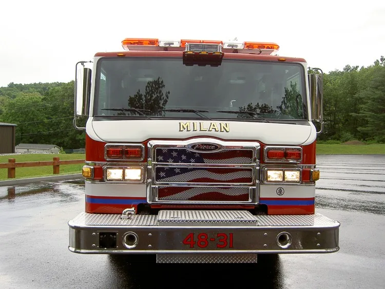 Front exterior view showing grille, bumper, and warning lights