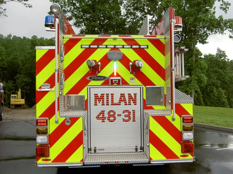 Rear view showing chevron striping, rear door panel, and warning lights