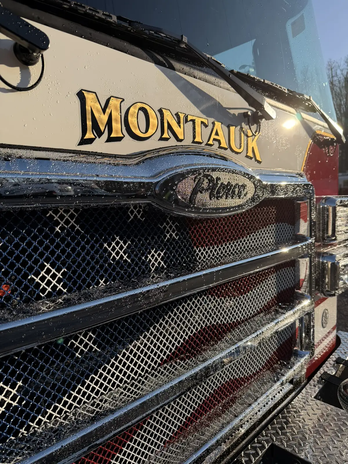 Front grille close-up showing gold hood lettering and Pierce badge