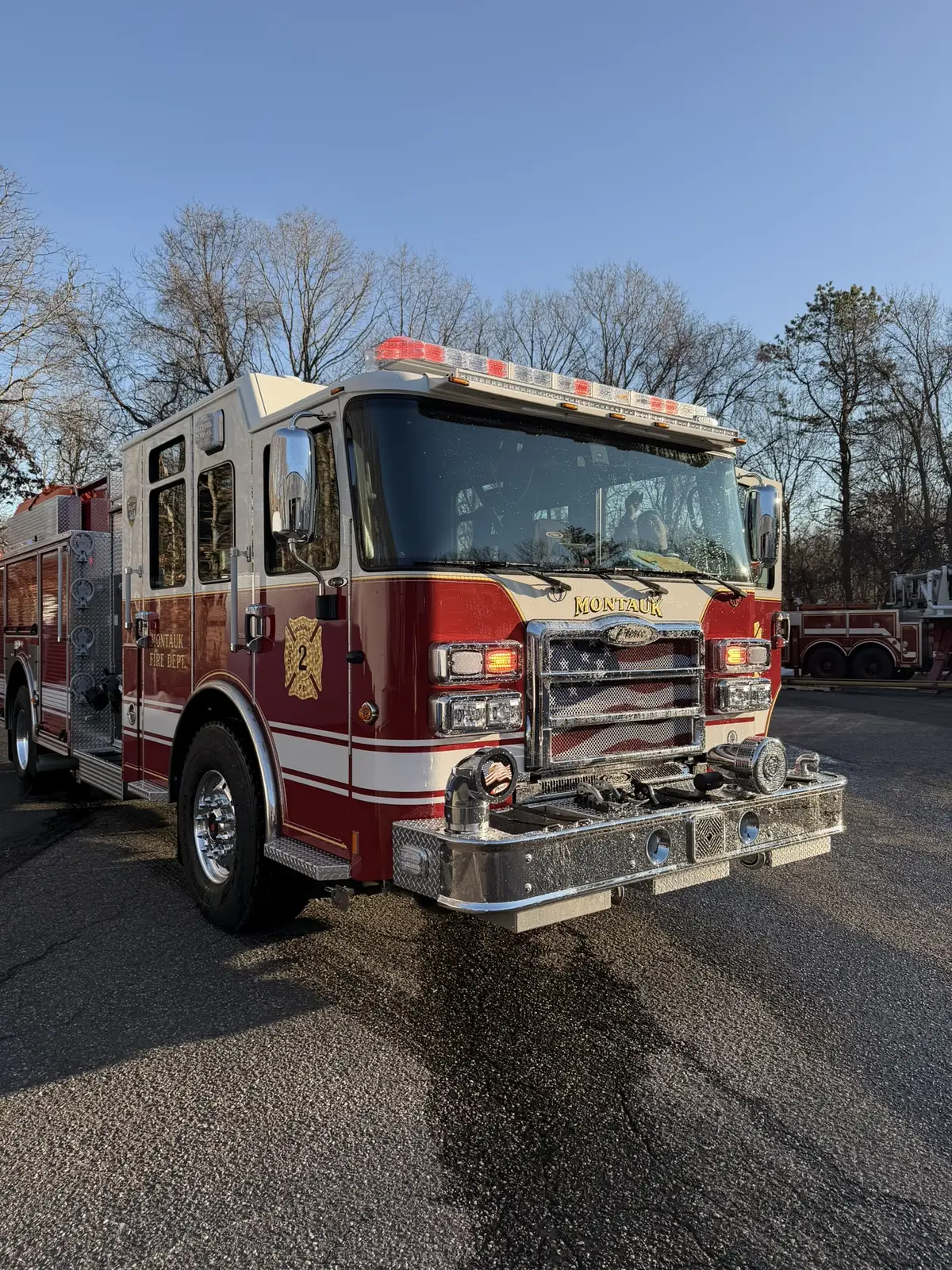 Front-left exterior view showing grille, bumper, and side body striping