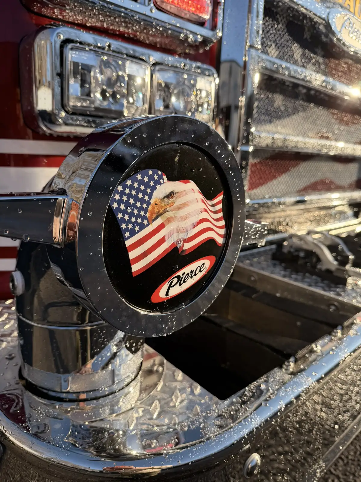 Steering wheel close-up showing center logo and spoke controls