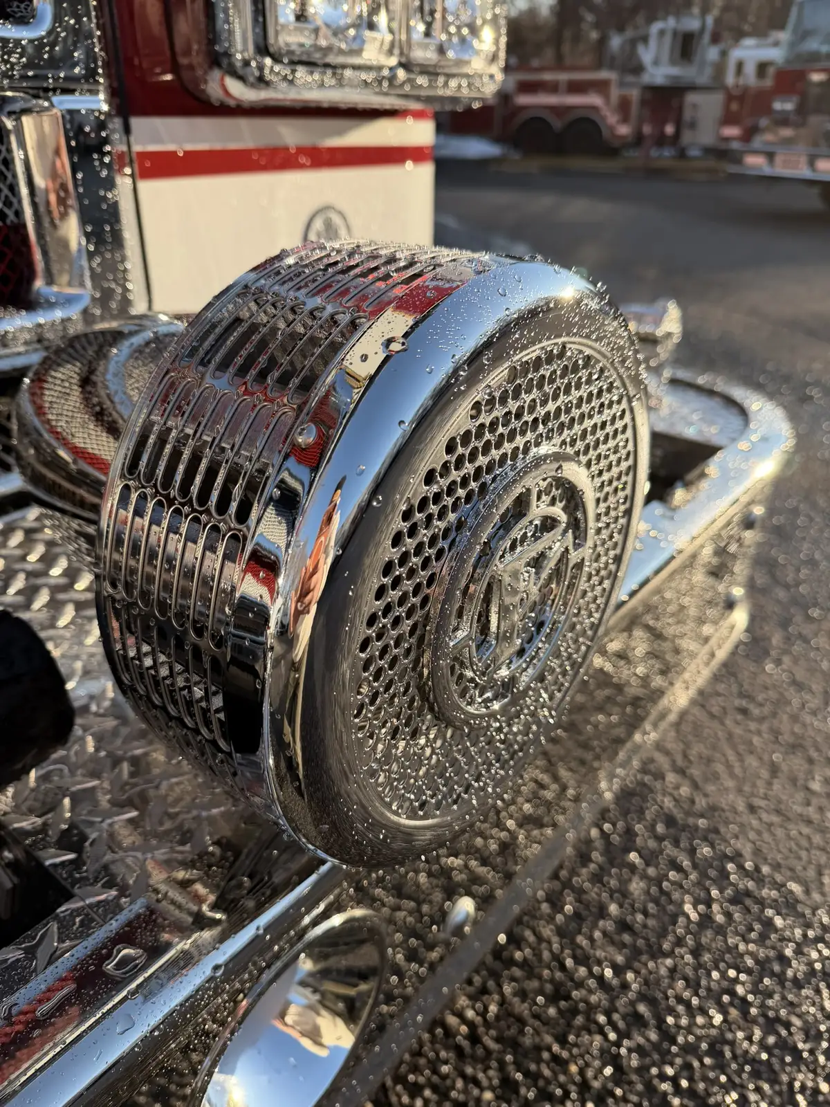 Front bumper intake close-up showing chrome intake cap and diamond-plate deck