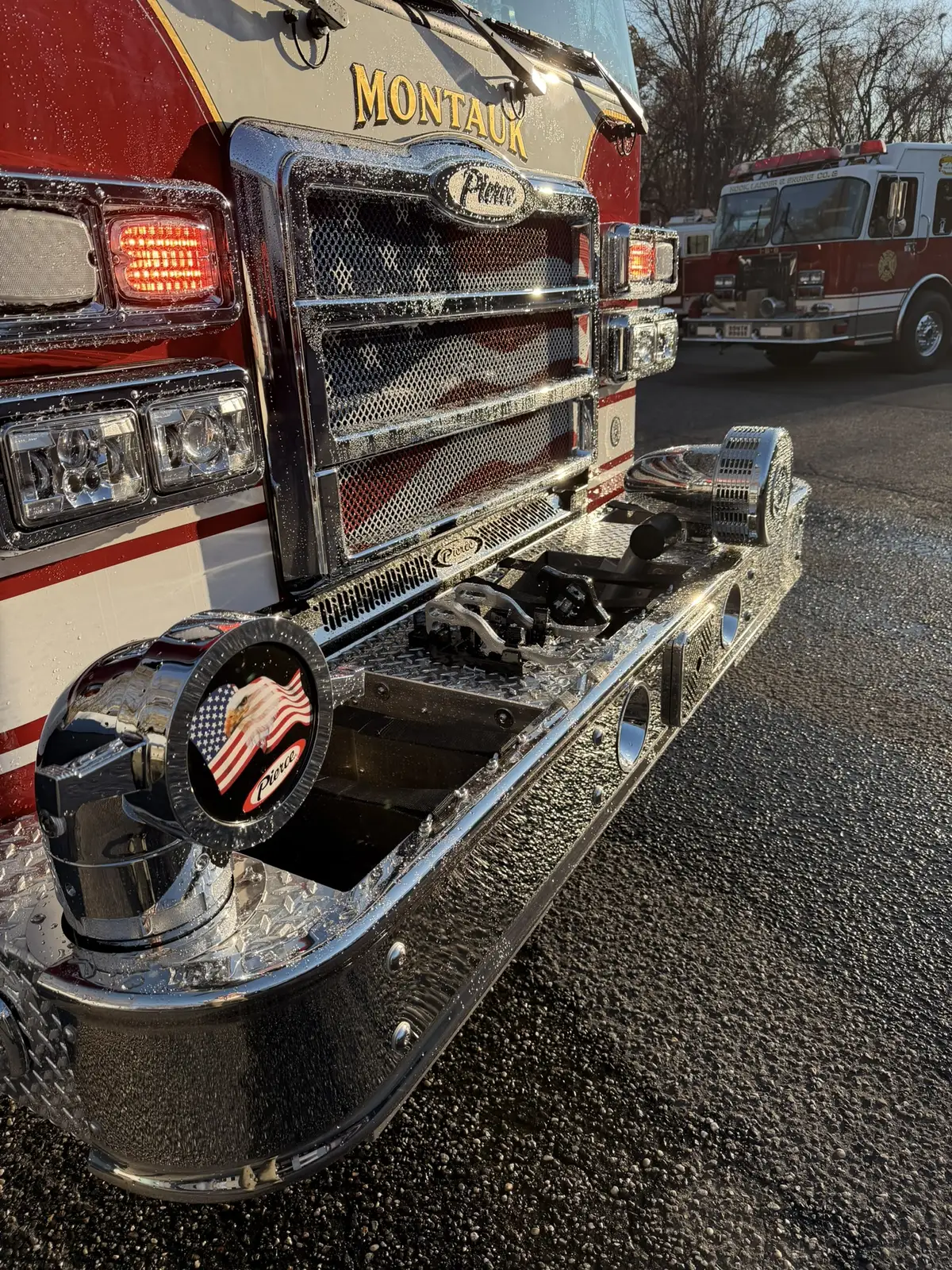 Front bumper hardware close-up showing intake fitting and chrome trim
