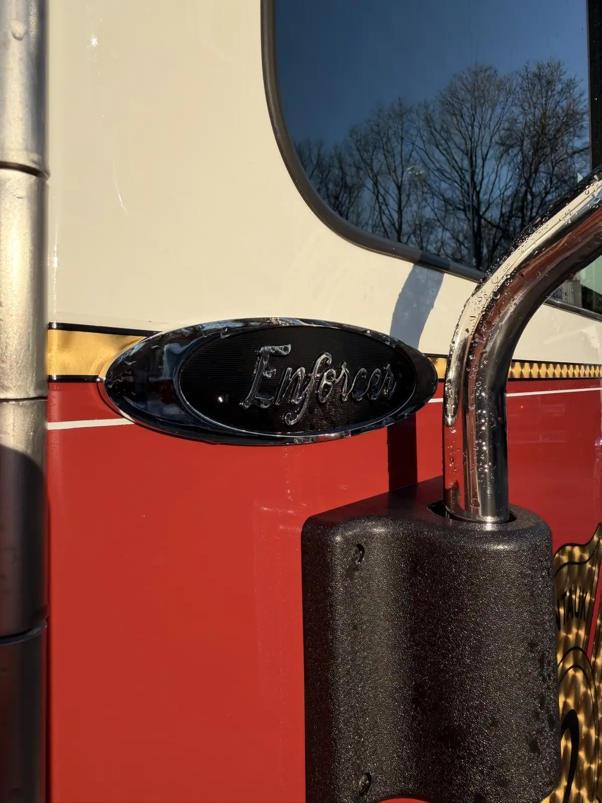 Cab-side close-up showing Enforcer badge and mirror support mount