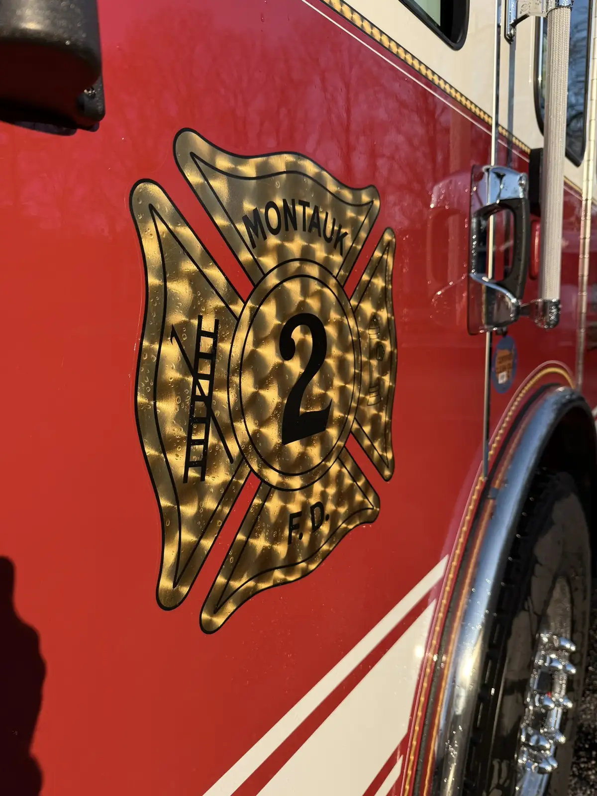 Cab door crest close-up showing logo shield and reflective striping