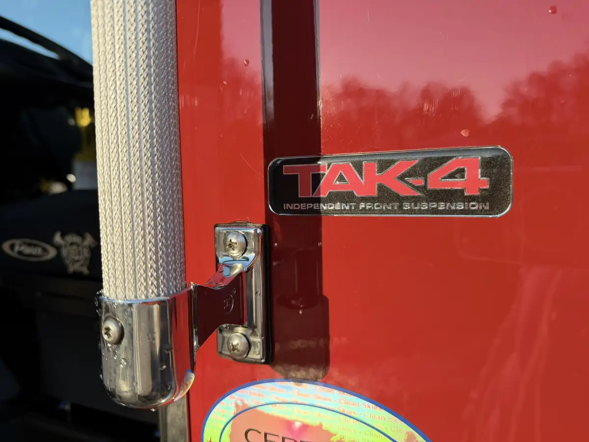 Body badge close-up showing TAK-4 suspension emblem