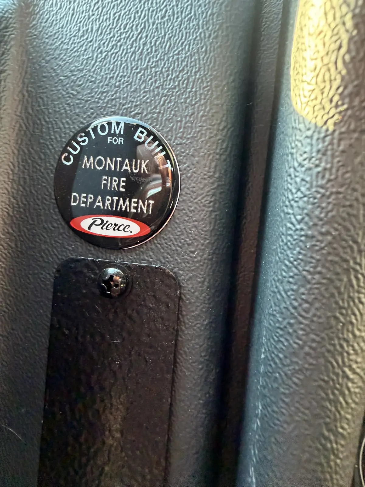 Cab control close-up showing parking brake knob and nearby panel switch