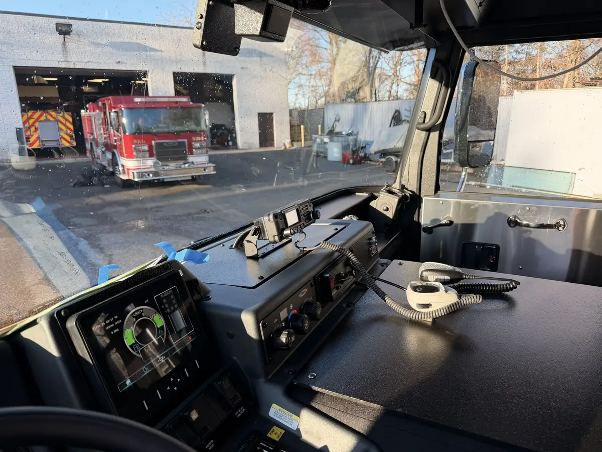 Cab interior wide view showing dashboard, center console, and front seats