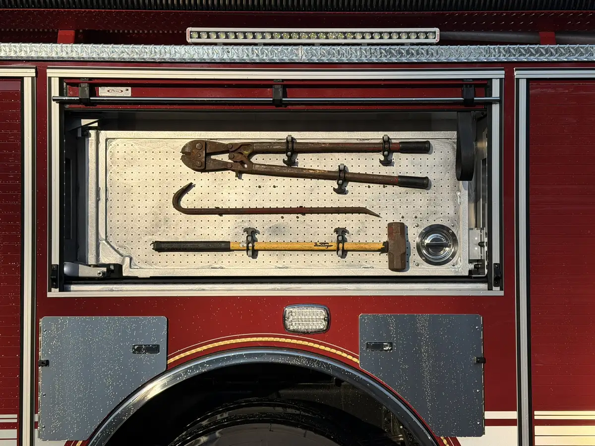 Open side toolboard compartment showing mounted hand tools and fittings