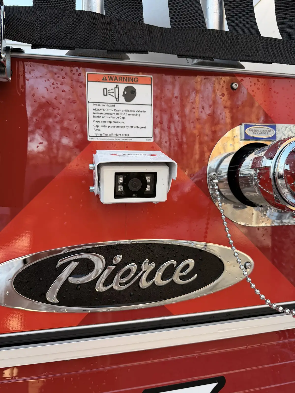 Rear panel close-up showing rear camera, Pierce badge, and discharge outlet