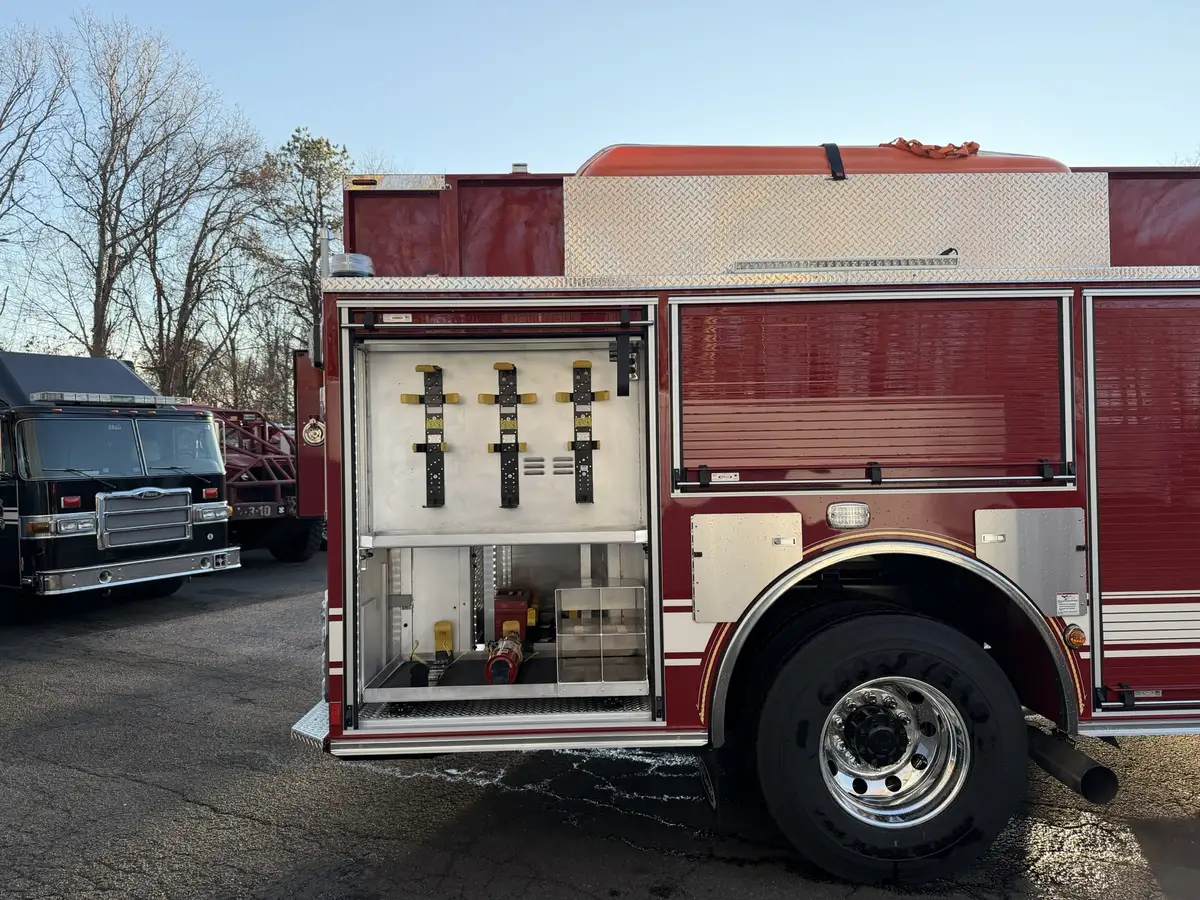 Officer-side profile view showing open compartments, wheel area, and side body