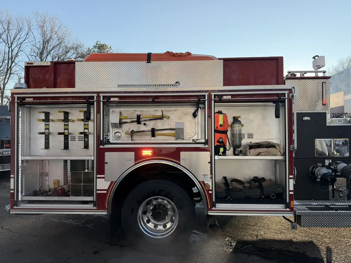 Officer-side profile view with open compartments showing tools and shelf storage