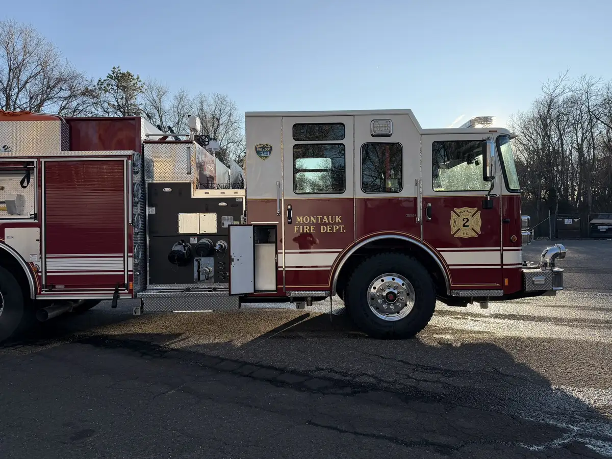 Driver-side profile view showing pump panel, cab, and wheel area