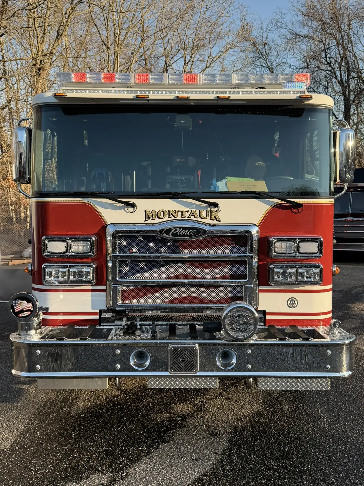 Head-on front exterior view showing grille, bumper, and warning lights
