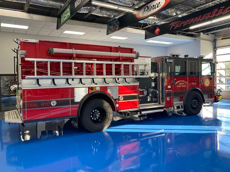 Driver-side profile view showing pumper body and rear wheel area