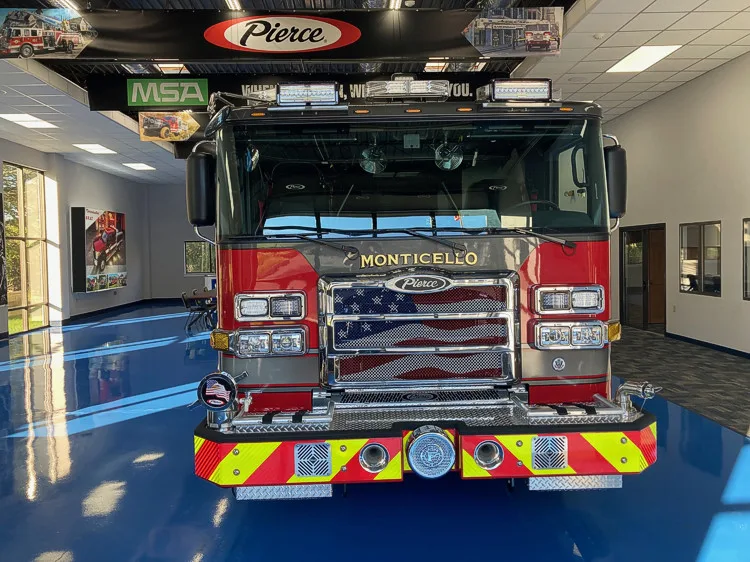 Head-on front view showing grille, bumper, and warning lights