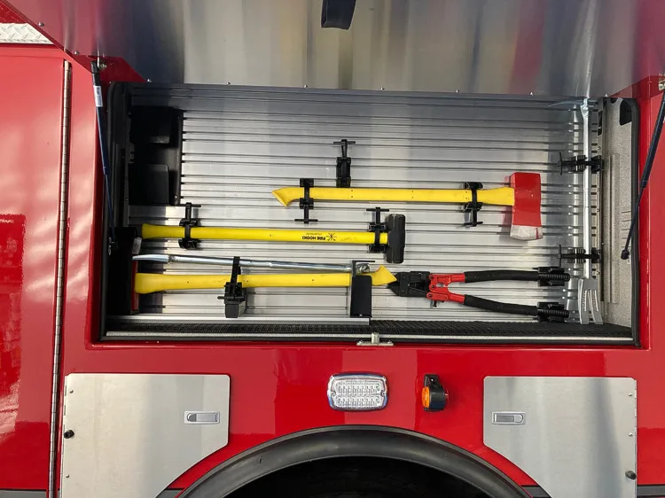 Open side compartment showing mounted hand tools and long-tool rack