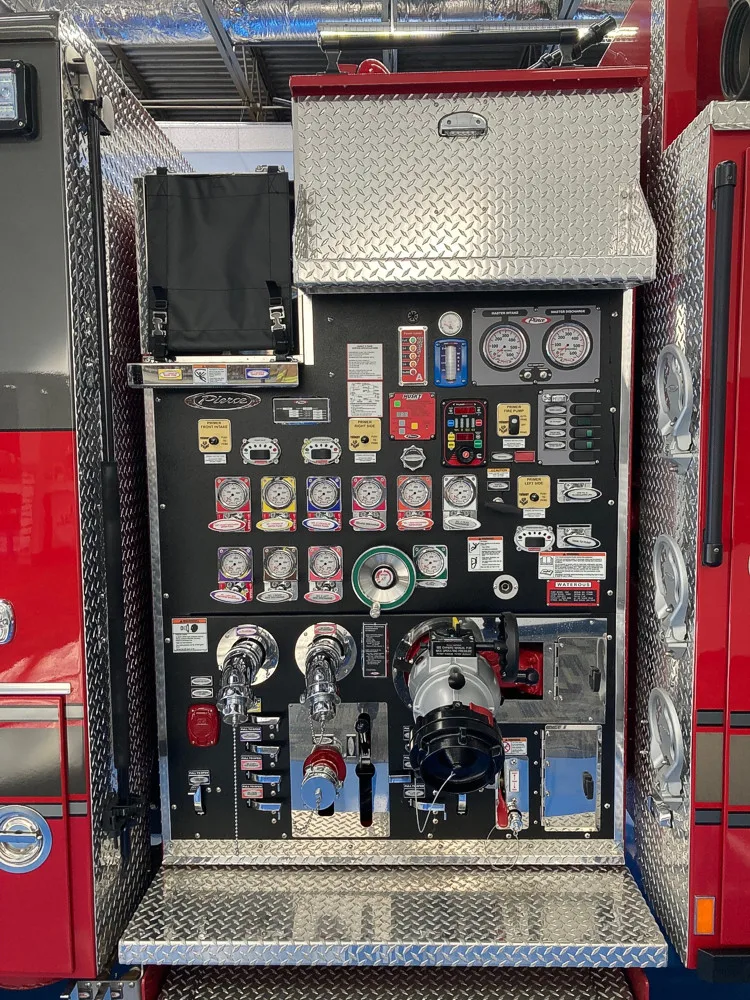 Pump panel close-up showing gauges, valves, and intake controls