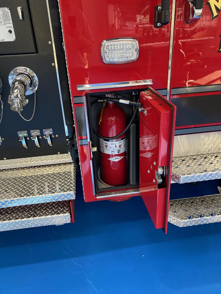 Open narrow side compartment showing extinguisher and side shelf