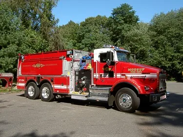 Front-right exterior view showing hood, cab, and side body compartments