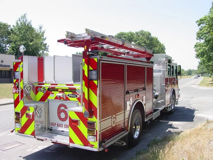 Rear-right exterior view showing side hosebed rails and rear wheel area