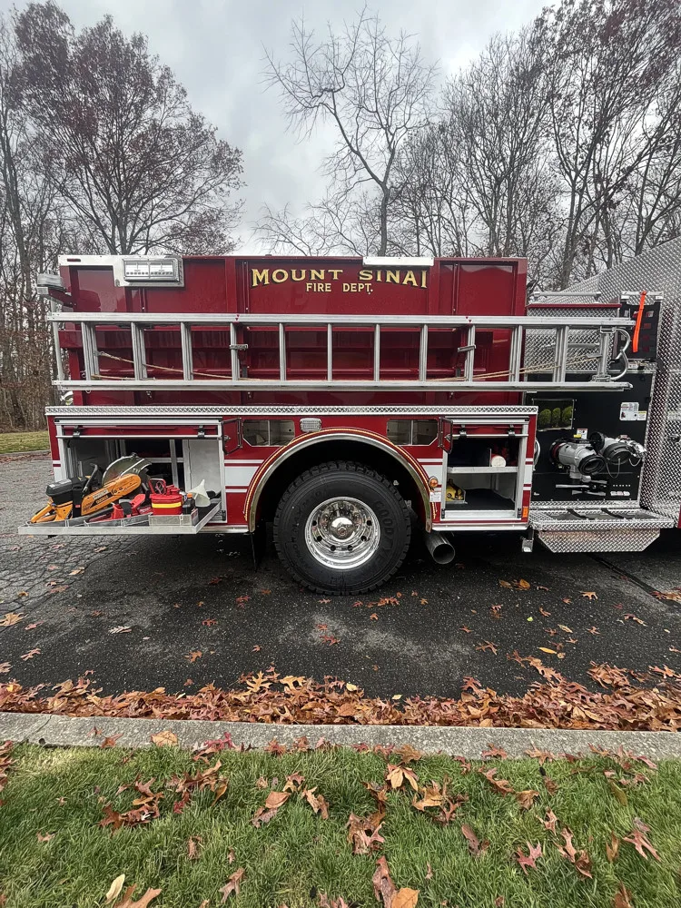 Driver-side profile showing pumper body and side compartments