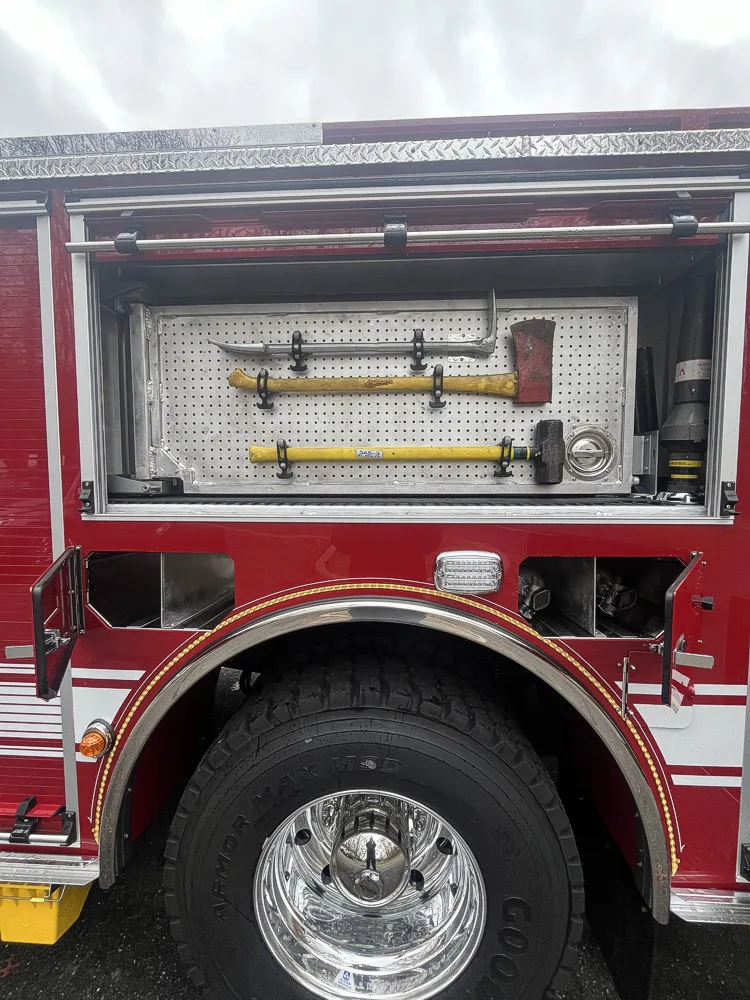 Open side compartment showing mounted hand tools in horizontal rack