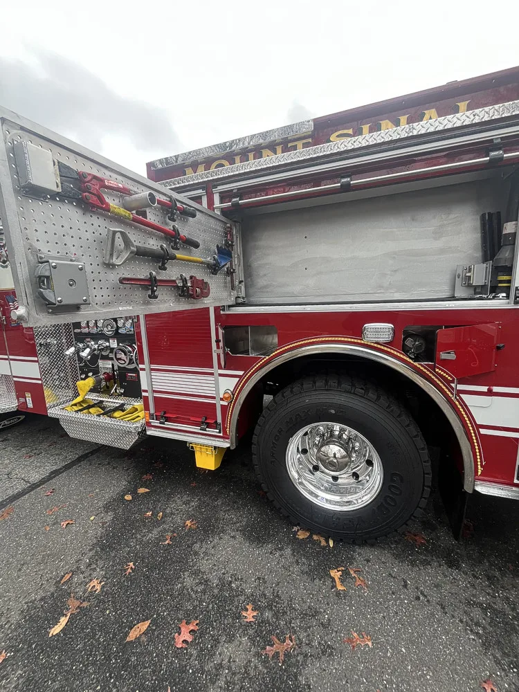 Driver-side profile with open compartments showing full equipment layout