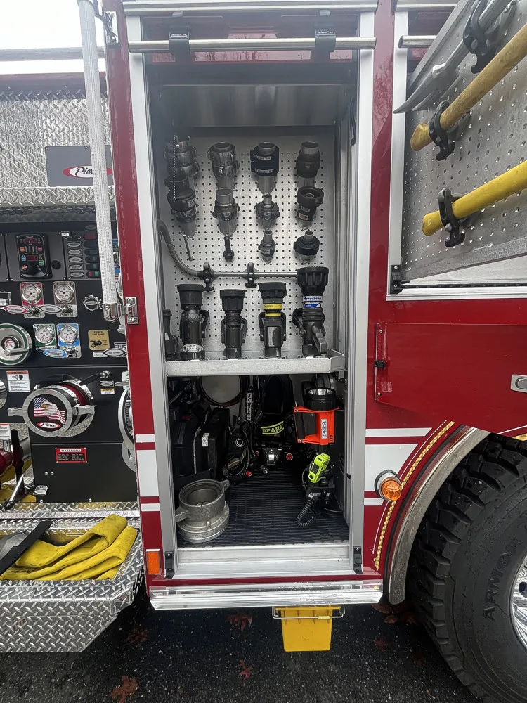 Open pump panel compartment showing gauges, valves, and lever controls