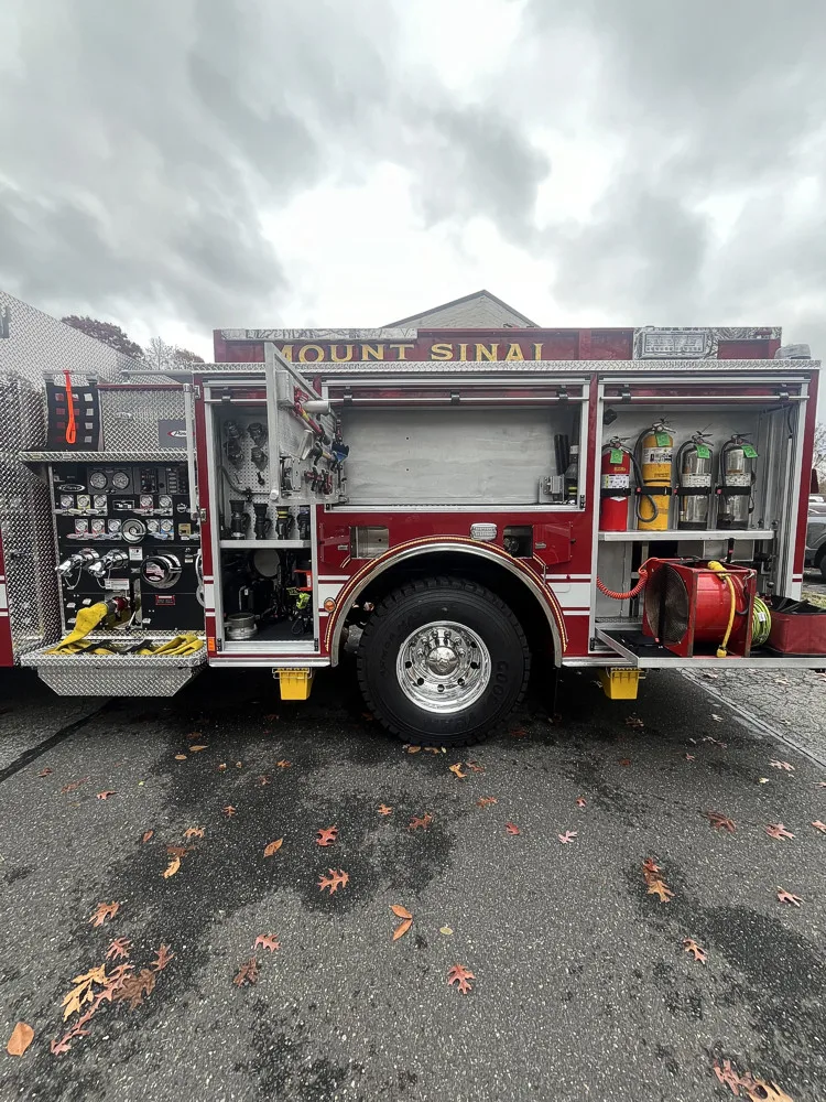 Driver-side profile with open compartments and wheel area visible